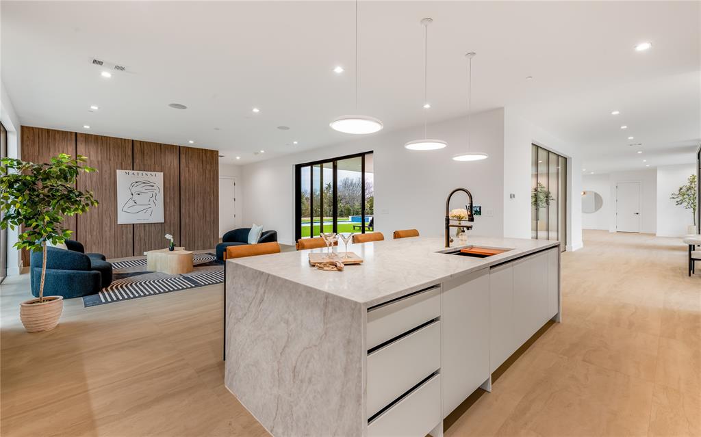 229 Sunset Pt Trail Heath, TX 75032 - Photo 12 of 40 a large white kitchen with a large island in the center