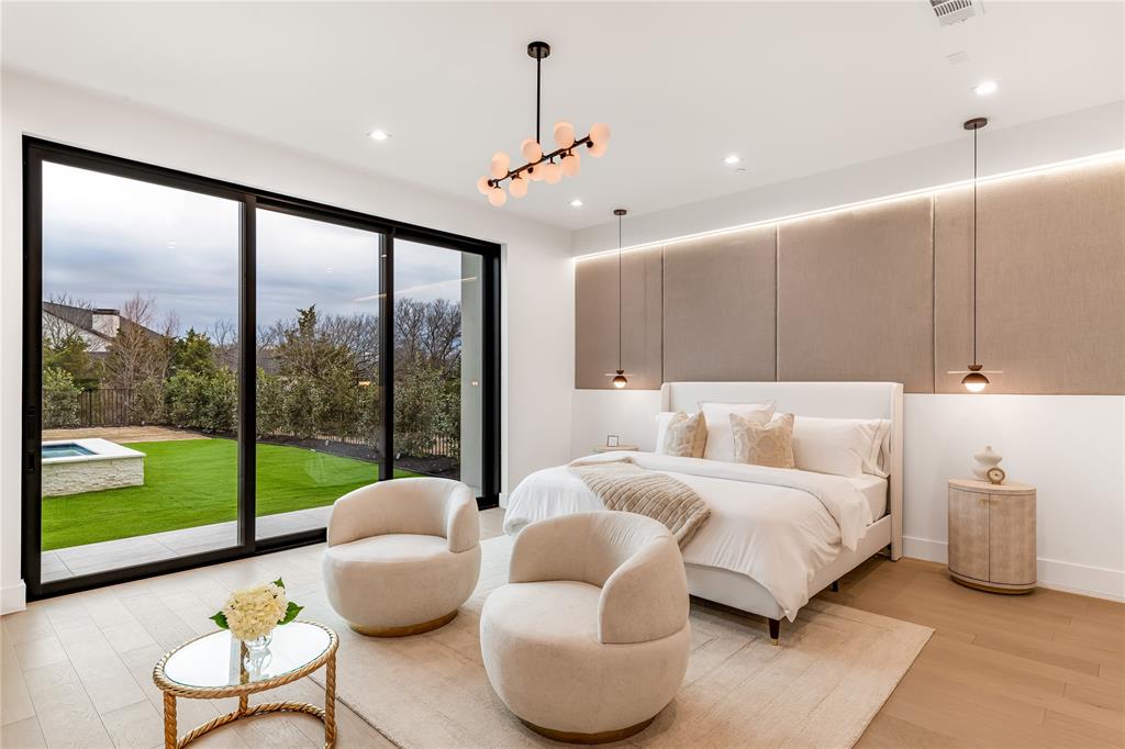 229 Sunset Pt Trail Heath, TX 75032 - Photo 17 of 40 a spacious bedroom with a bed and a large window