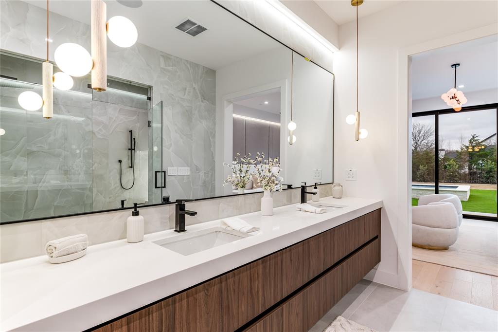229 Sunset Pt Trail Heath, TX 75032 - Photo 24 of 40 a bathroom with a double vanity sink and a mirror