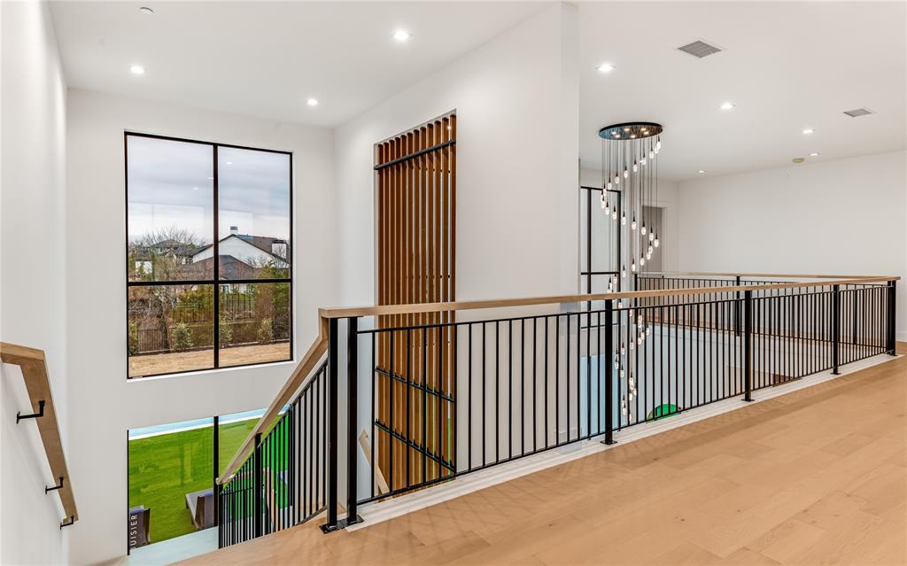 229 Sunset Pt Trail Heath, TX 75032 - Photo 26 of 40 a view of a hallway with wooden floor and windows