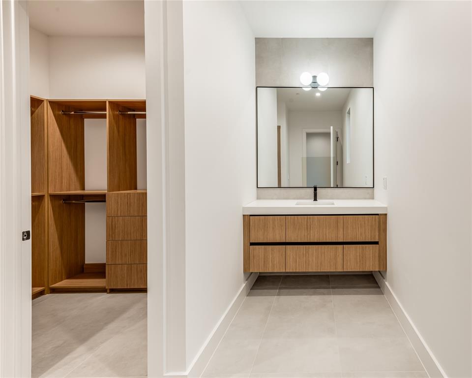 229 Sunset Pt Trail Heath, TX 75032 - Photo 29 of 40 a bathroom with a sink a light fixture and a mirror
