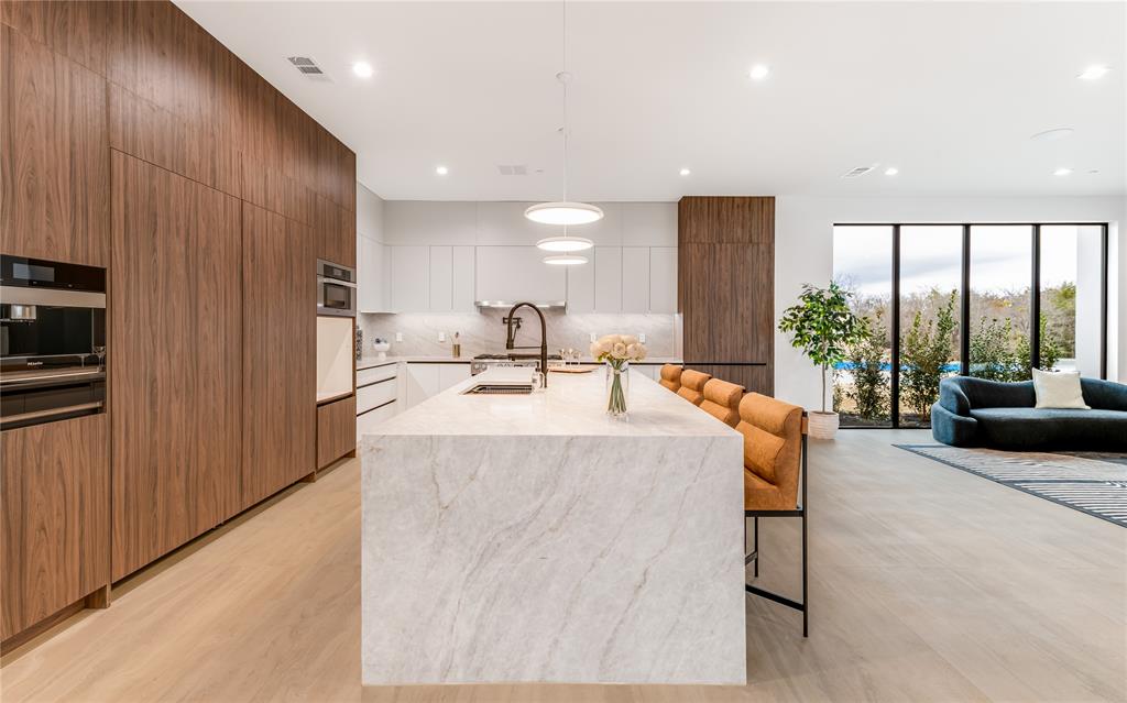 229 Sunset Pt Trail Heath, TX 75032 - Photo 9 of 40 a living room with large window furniture and a kitchen view