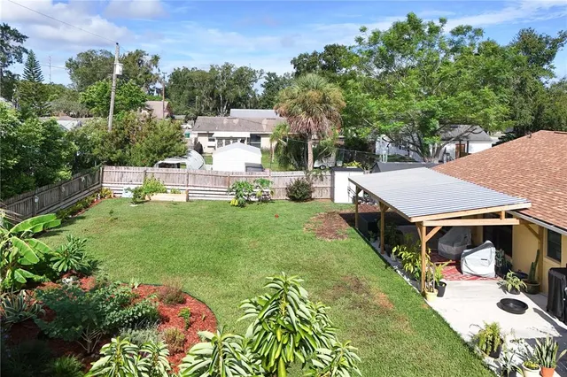 an aerial view of a house with swimming pool garden and patio