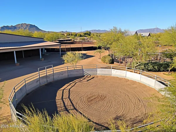 an aerial view of a house with a swimming pool yard and mountain view in back