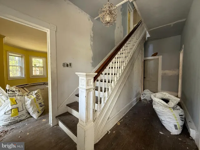 a view of a livingroom with furniture and stairs
