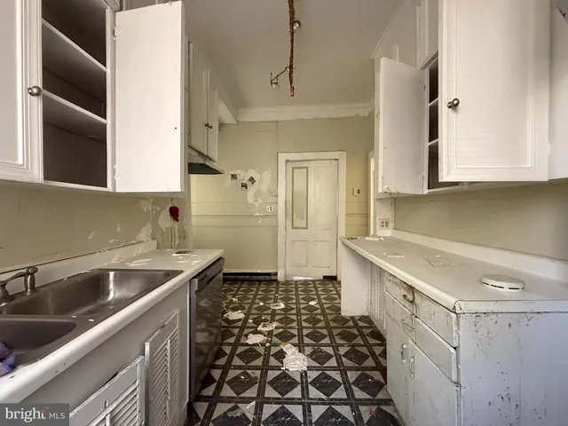 a kitchen with a sink and cabinets