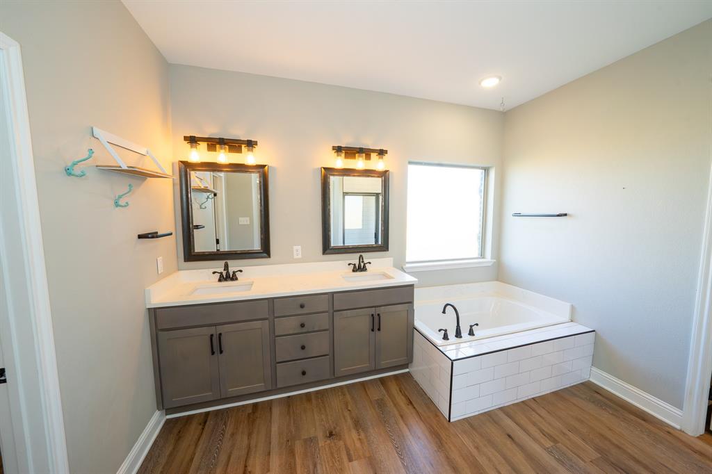 132 Addie Way Tuscola, TX 79562 - Photo 13 of 37 a bathroom with a bathtub sink and mirror