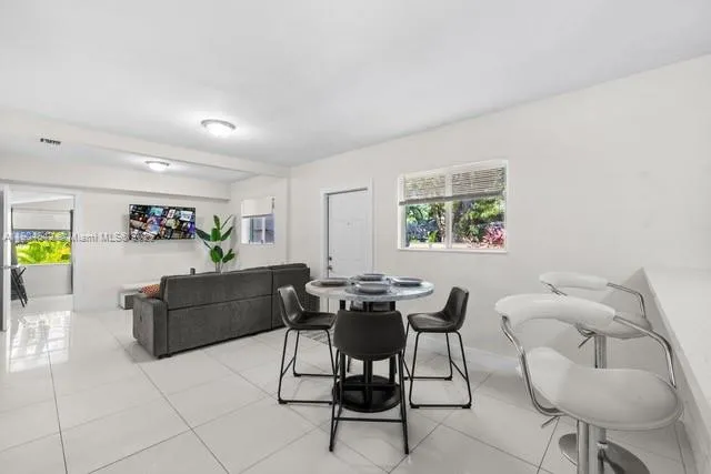 a living room with furniture and painting on the wall