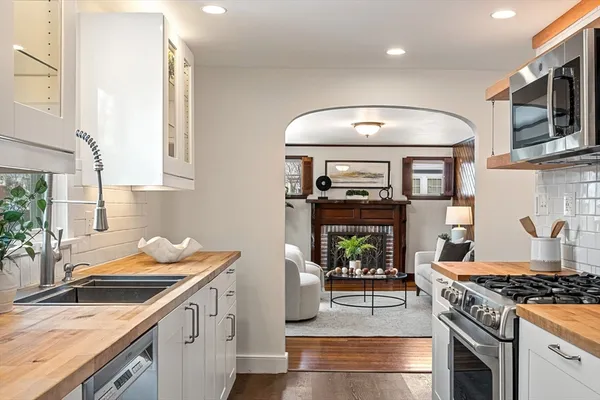 a kitchen with a sink stove and cabinets