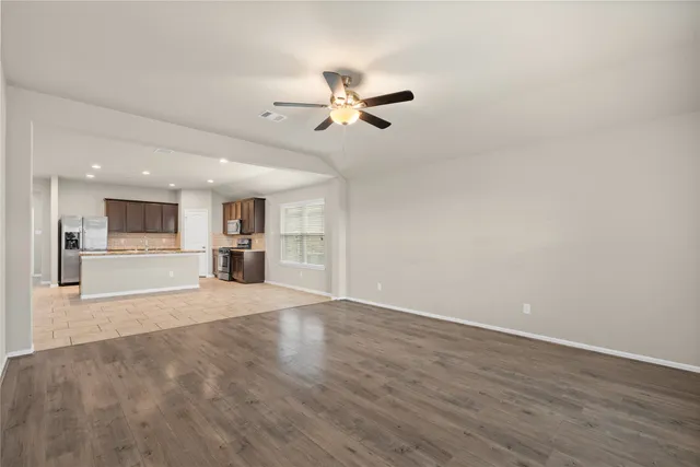a view of a kitchen with wooden floor and a kitchen