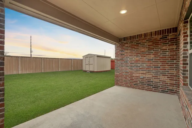 a view of a backyard with wooden fence