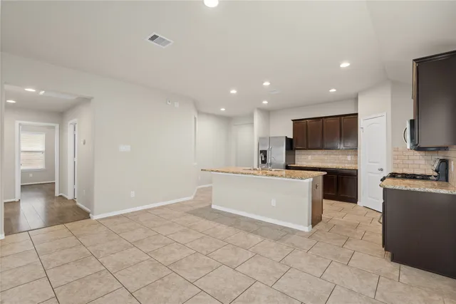 a large white kitchen with cabinets