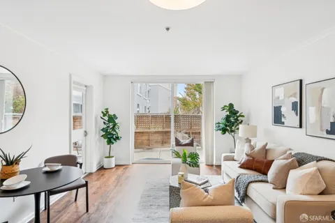 a living room with furniture and a potted plant