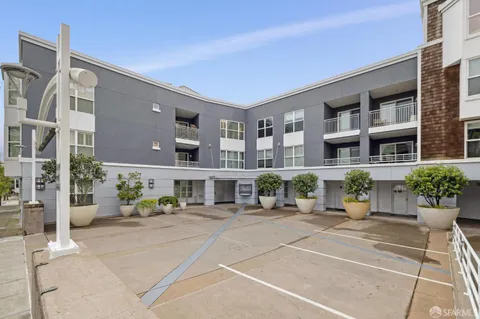 a view of staircase with lots of frames on wall and a large window
