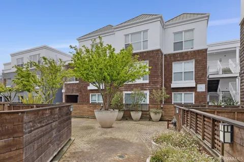 a view of a water fountain and potted plants
