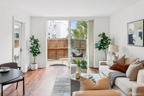 a living room with furniture and a potted plant