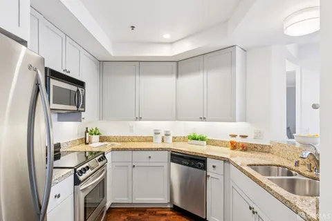a kitchen with a sink stove top oven and refrigerator