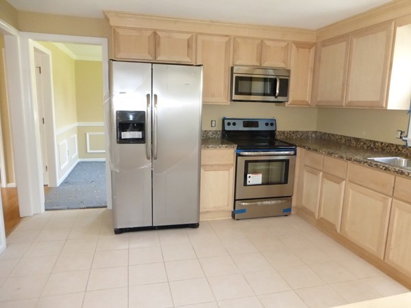 8 Metacomet Road Longmeadow, MA 01106 - Photo 3 of 16 a kitchen with granite countertop a refrigerator and a stove top oven