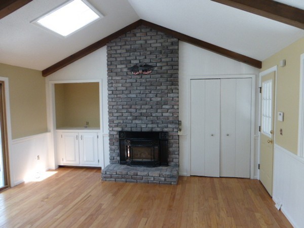 8 Metacomet Road Longmeadow, MA 01106 - Photo 4 of 16 a view of empty room with wooden floor and fireplace