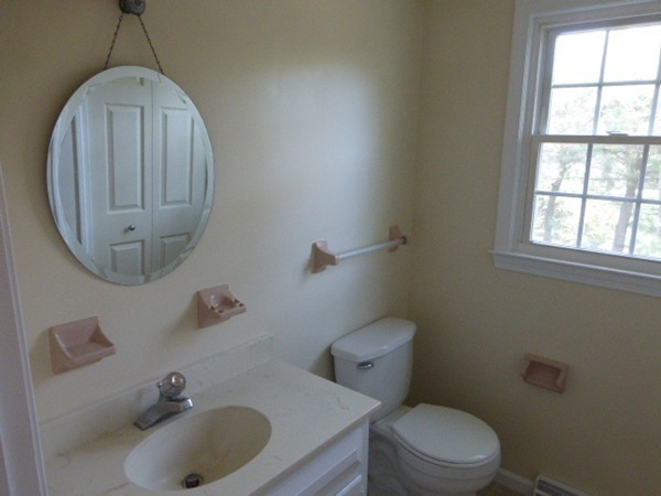 8 Metacomet Road Longmeadow, MA 01106 - Photo 8 of 16 a bathroom with a sink a toilet and a mirror