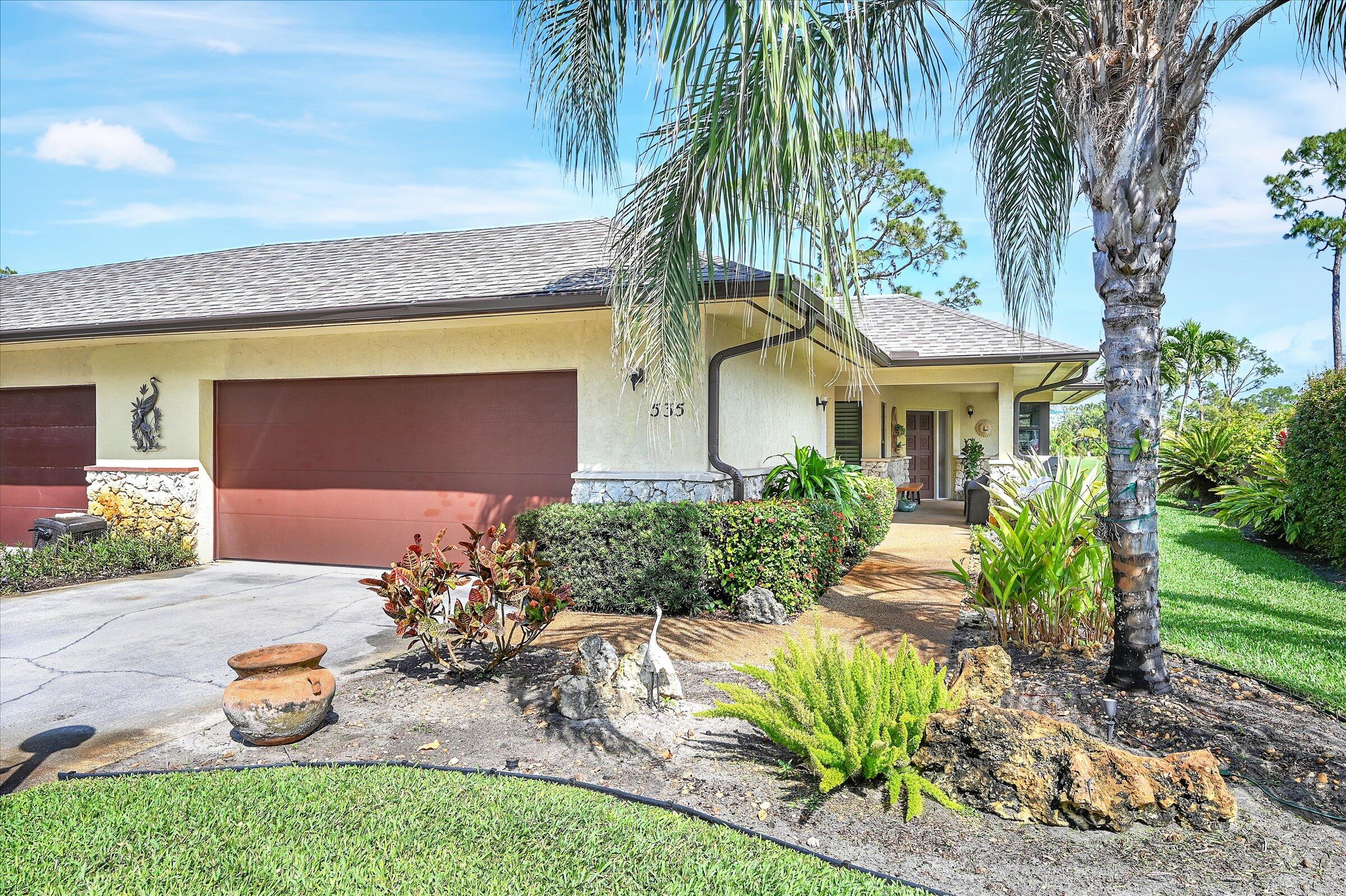 535 Augusta Boulevard, Unit 4 Naples, FL 34113 - Photo 2 of 44 a front view of a house with a yard