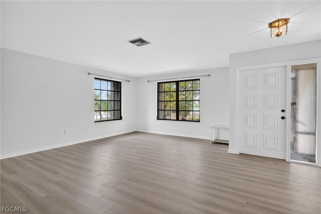 1312 Par View Drive Sanibel, FL 33957 - Photo 14 of 45 an empty room with wooden floor and windows