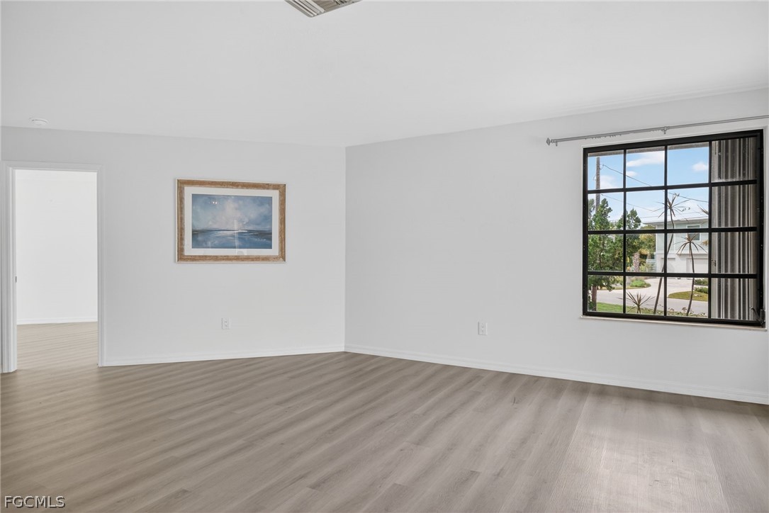 1312 Par View Drive Sanibel, FL 33957 - Photo 15 of 45 a view of an empty room with wooden floor and a window