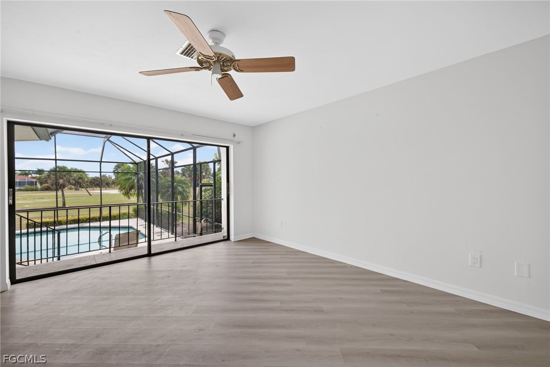 1312 Par View Drive Sanibel, FL 33957 - Photo 16 of 45 an empty room with wooden floor and windows