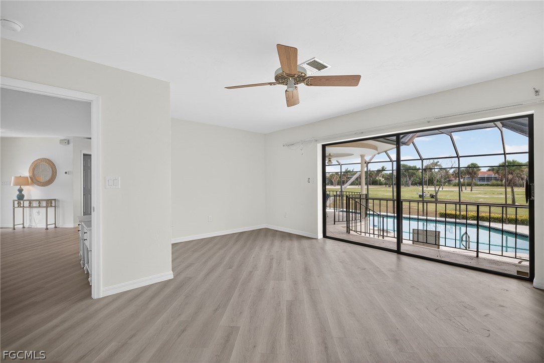 1312 Par View Drive Sanibel, FL 33957 - Photo 17 of 45 an empty room with wooden floor and windows