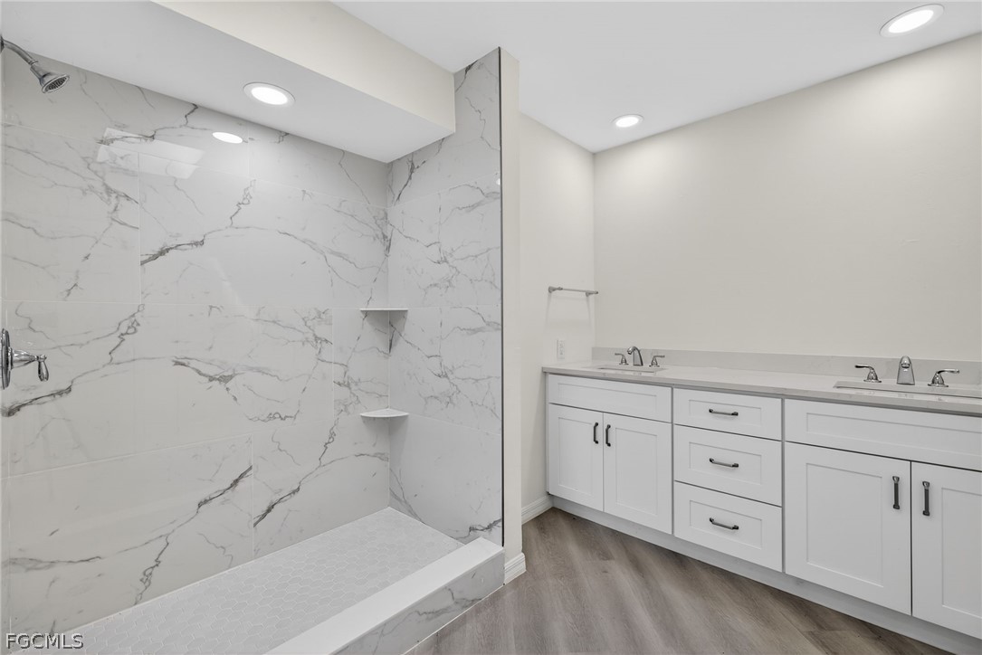 1312 Par View Drive Sanibel, FL 33957 - Photo 19 of 45 a spacious bathroom with a granite countertop sink mirror and shower