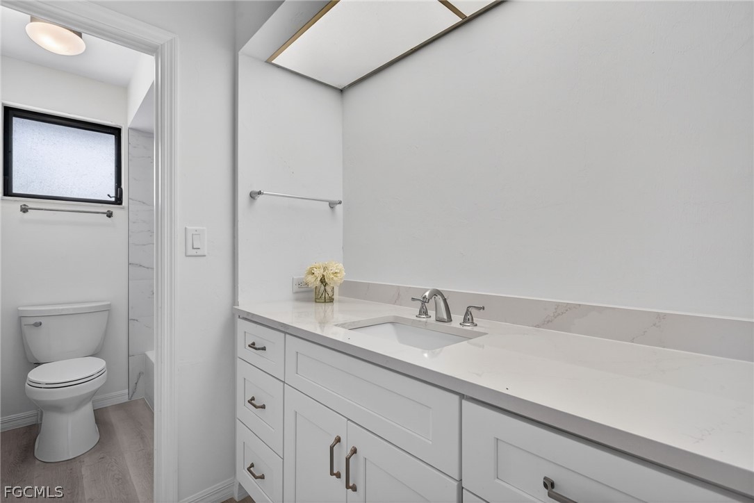 1312 Par View Drive Sanibel, FL 33957 - Photo 23 of 45 a bathroom with a toilet sink and mirror
