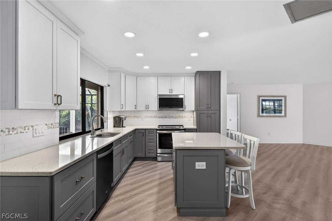 1312 Par View Drive Sanibel, FL 33957 - Photo 4 of 45 a large kitchen with stainless steel appliances kitchen island granite countertop a sink and cabinets