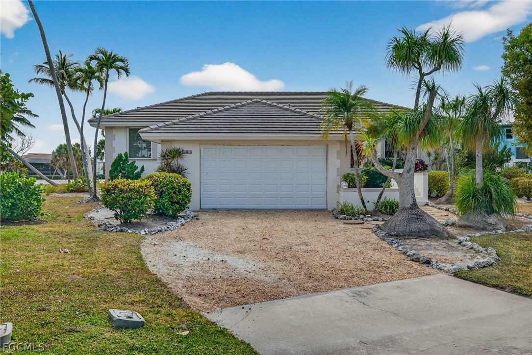 1312 Par View Drive Sanibel, FL 33957 - Photo 44 of 45 a front view of a house with a yard and garage