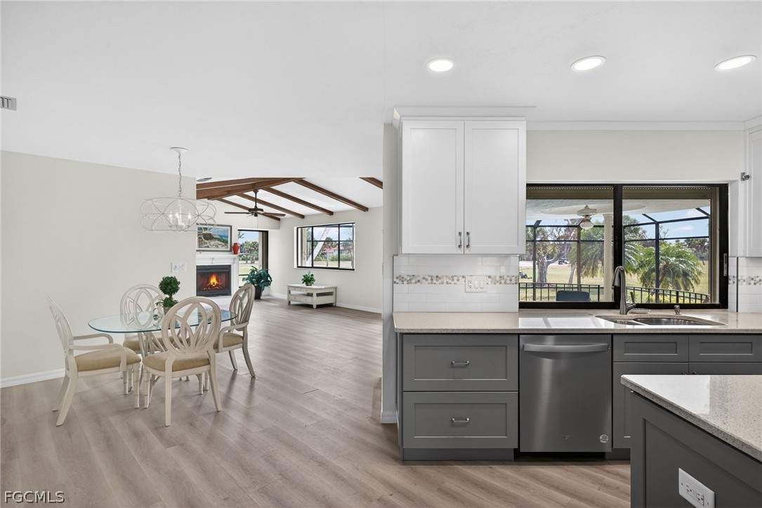 1312 Par View Drive Sanibel, FL 33957 - Photo 9 of 45 a kitchen with granite countertop white cabinets and stainless steel appliances
