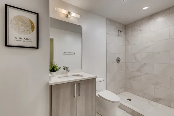 a bathroom with a sink mirror and toilet
