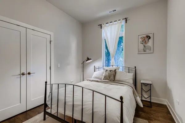 a bedroom with a bed and a window