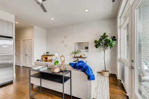 a living room with furniture and a potted plant