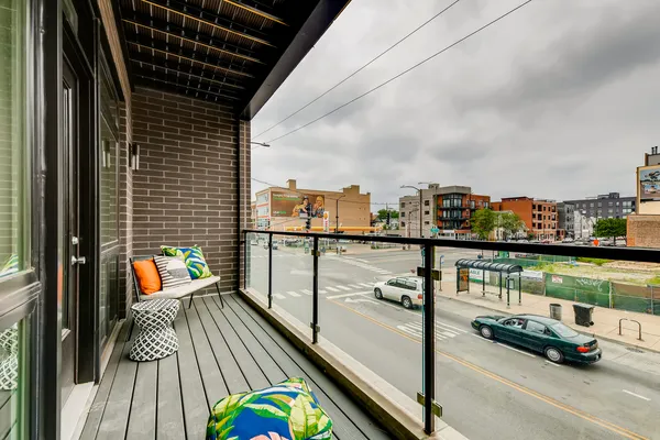 a view of a balcony with wooden floor and outdoor seating