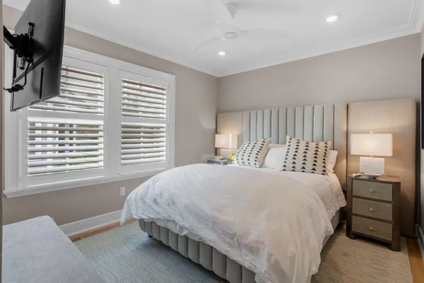 a spacious bedroom with a bed and a lamp