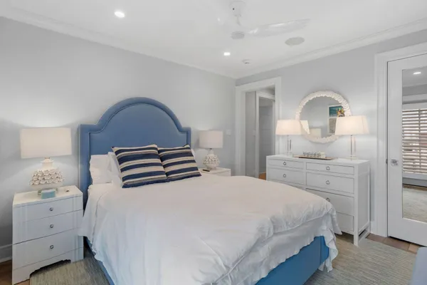 a bed sitting in a bedroom next to a window