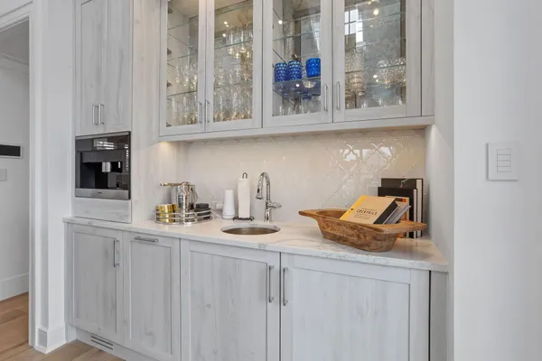 a kitchen with a sink chairs and cabinets