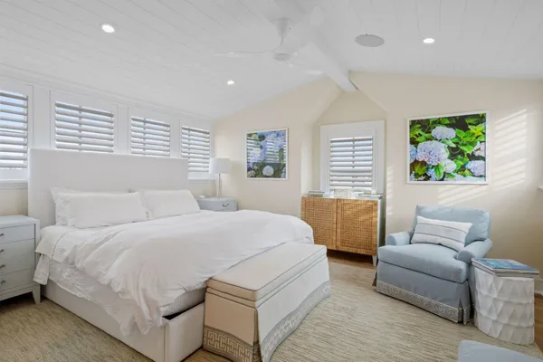 a spacious bathroom with a double vanity sink a mirror a bathtub and