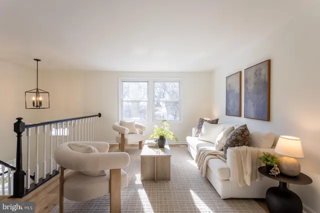 a view of a dining room with furniture a chandelier and wooden floor
