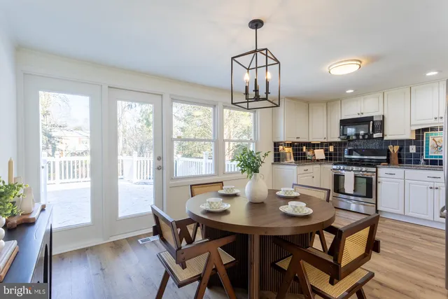 a view of a dining room with furniture wooden floor and a chandelier