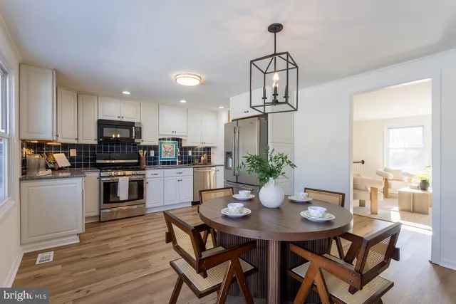 a kitchen with stainless steel appliances granite countertop a stove a refrigerator and a microwave