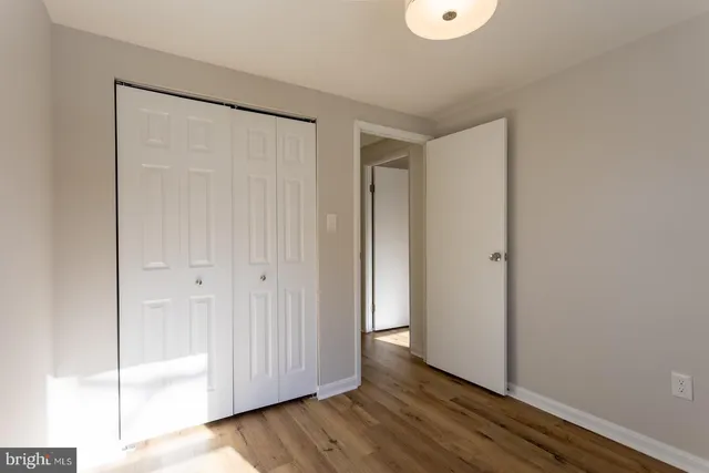 a bathroom with a granite countertop sink a toilet and a mirror