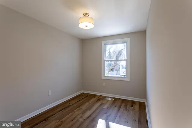 a view of hallway with stairs and wooden floor