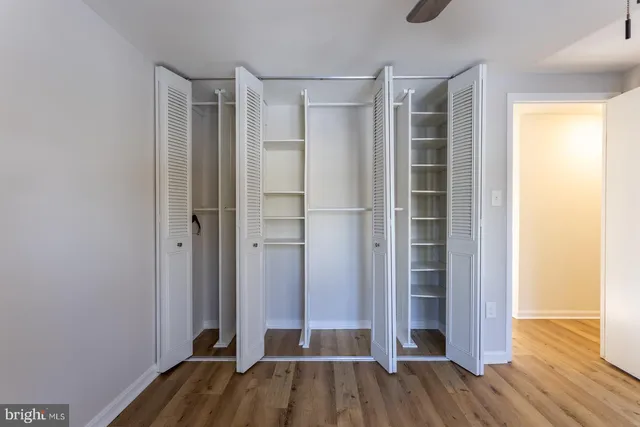 a bedroom with bed and a painting on the wall
