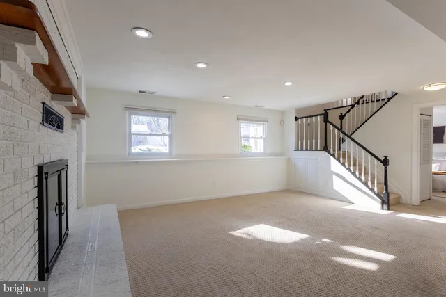 a view of house with a large window and wooden fence