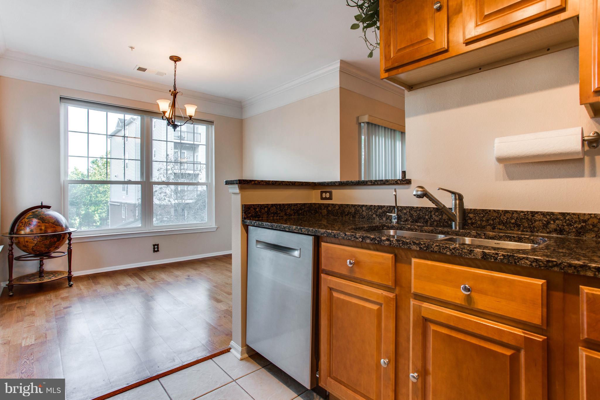 1600 Spring Gate Dr., Unit 2207 McLean, VA 22102 - Photo 14 of 29 a kitchen with stainless steel appliances granite countertop a sink stove and cabinets
